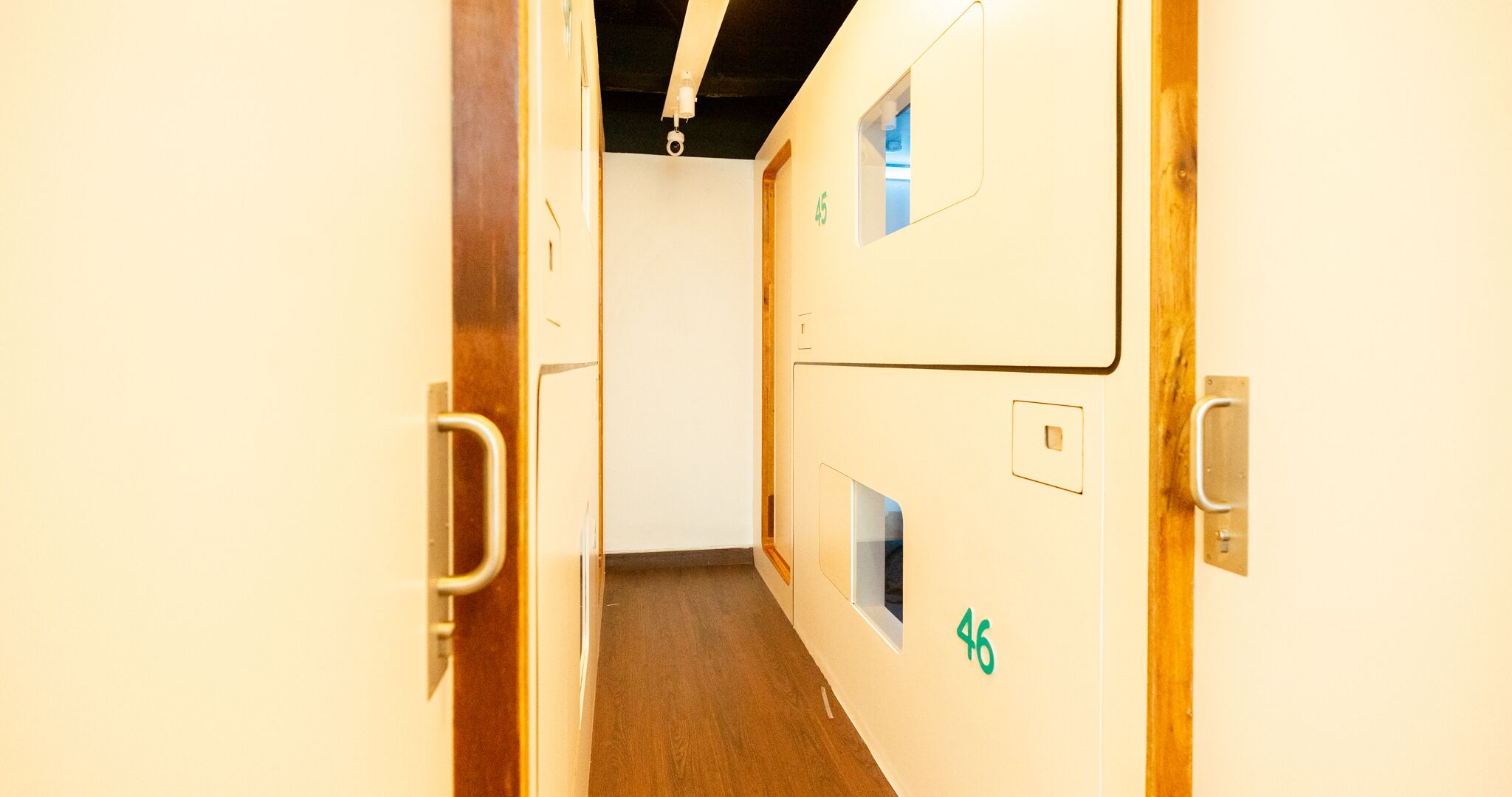 A narrow hallway with doors numbered 45 and 46, leading to rooms.