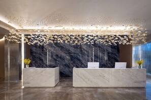 Welcome to our reception area, featuring a stylish desk and decorative ceiling installation.