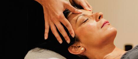 A person receiving a head massage.
