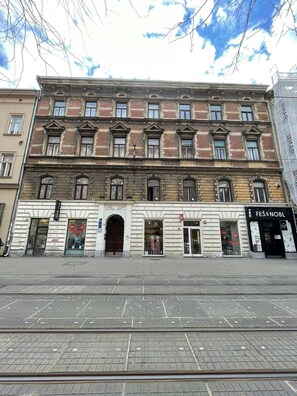 A historic building with multiple storefronts, including a visible shop named "FES & NOBL". - Bonne Chance Apartments (Zagreb)