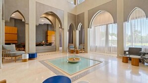 A spacious lobby with arched ceilings, a central water feature, and seating areas. - Villa Hana B (Marrakech)