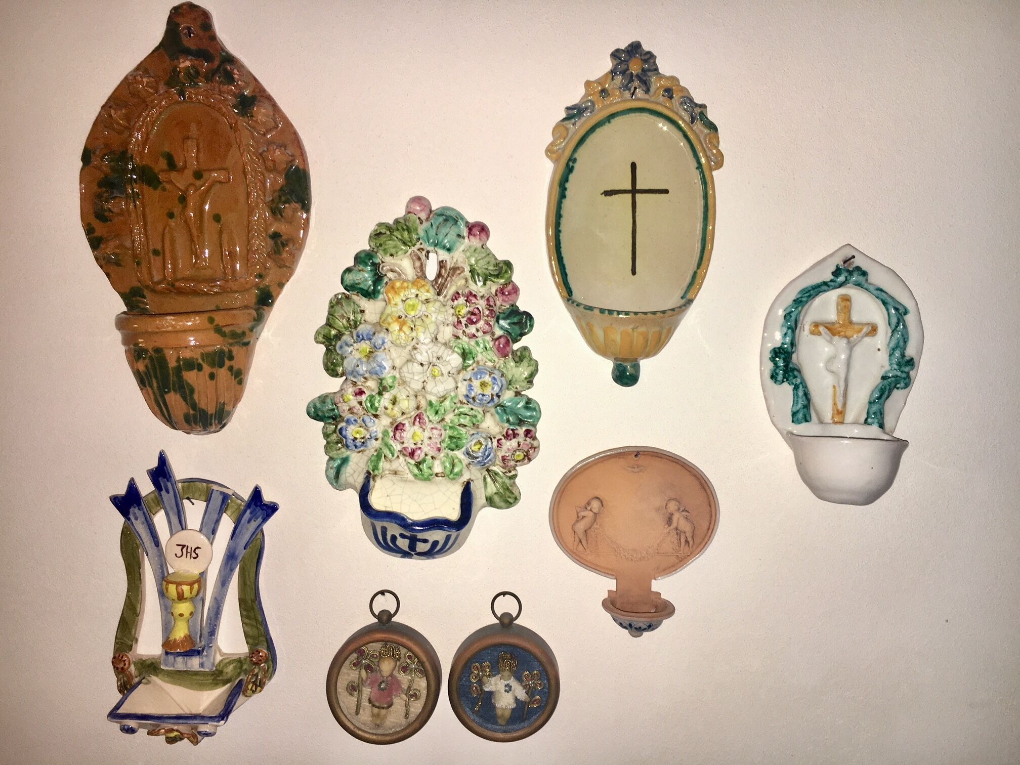 A collection of religious artifacts including a crucifix, a vase with flowers, and a menorah.
