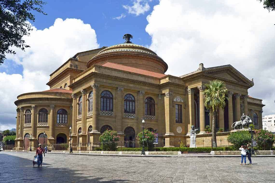 A historic building with a dome and classical architecture, featuring columns and arched windows.