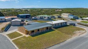 A residential area with multiple houses, a road, and a hilly landscape in the background. - Elliston Esplanade Beach House (RUFF-INN-IT) (Elliston)
