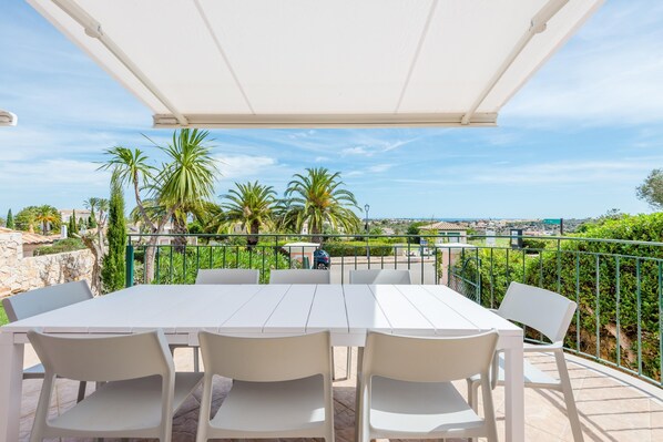 An outdoor patio with a white table and chairs, surrounded by a white canopy. - Casa Rosa at Boavista Resort (Lagos)