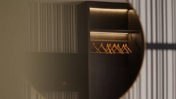 A circular view of a room with a wooden wardrobe, a hanging rack with clothes, and a striped wall pattern.