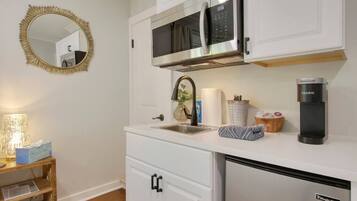 Fridge, microwave, coffee/tea maker, cookware/dishes/utensils