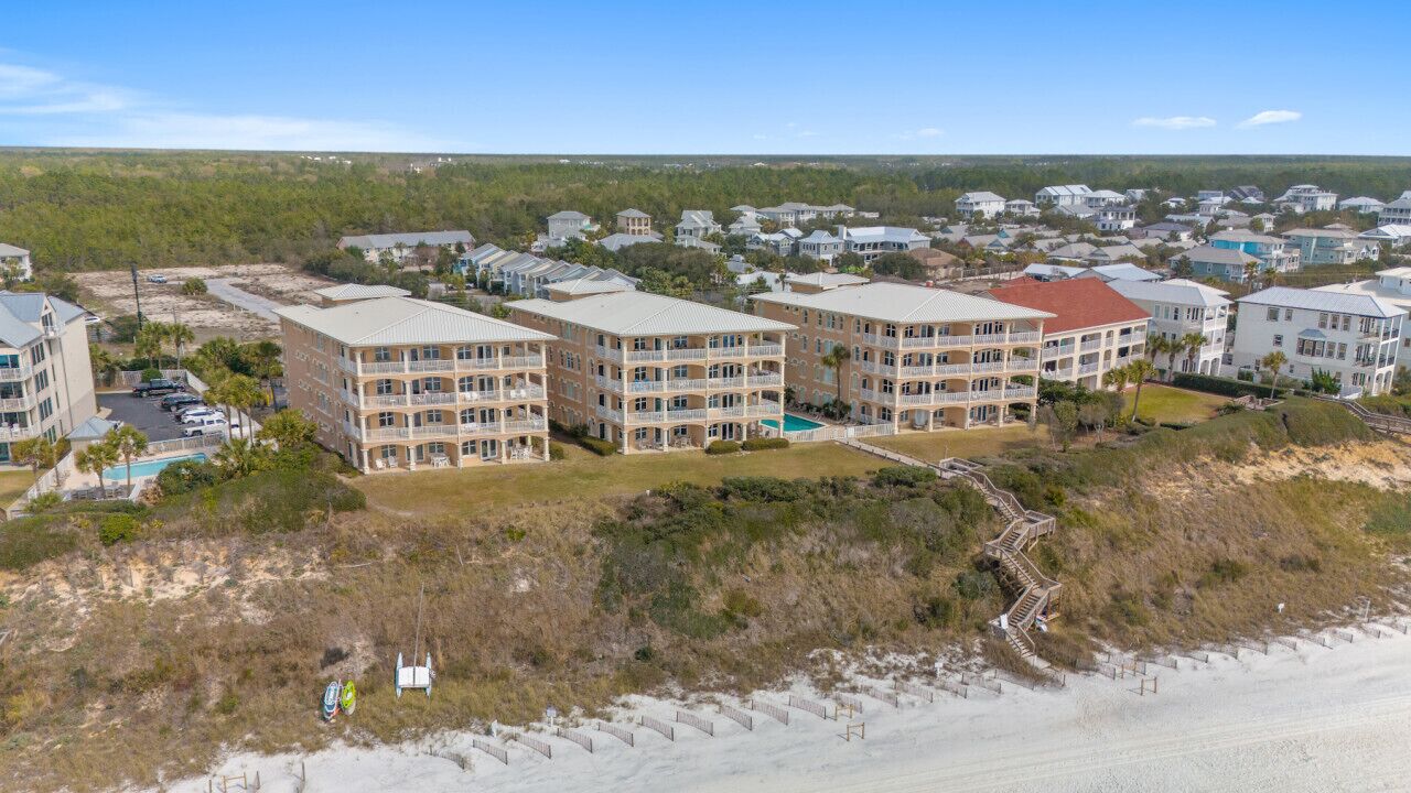 Ein Strandhotel mit mehrstöckigen Gebäuden, einem Schwimmbad und direktem Zugang zum Strand.