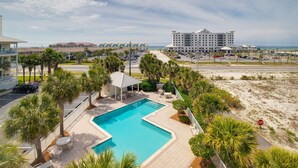 A resort with a swimming pool, beach view, and multiple buildings. - Awesome condo with pool, across from beach access (Navarre)