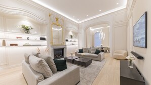 A modern living room with a fireplace, sofas, and a coffee table.
