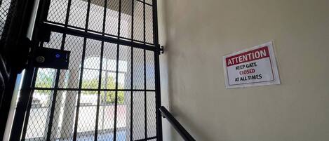 A metal gate with a sign instructing to keep it closed at all times.