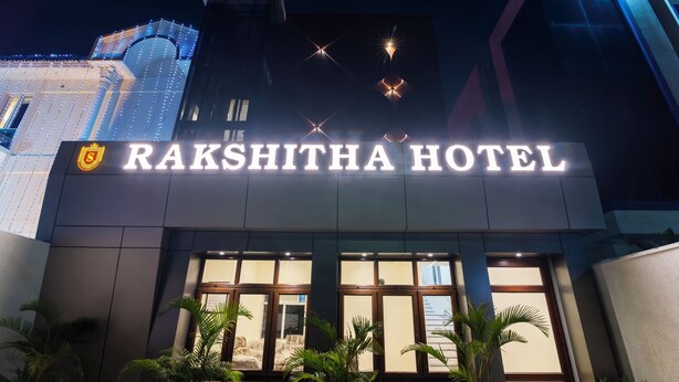 The exterior of Rakshitha Hotel with illuminated signage and a modern architectural design. - Treebo Rakshitha (Chennai)