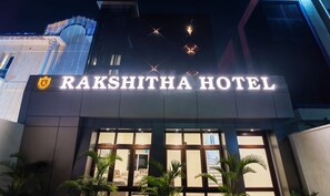 The exterior of Rakshitha Hotel with illuminated signage and a modern architectural design. - Treebo Rakshitha (Chennai)