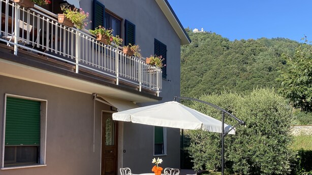 A two-story building with a balcony, outdoor seating, and a stone patio. - "COTTAGE ULIVO" 
Codice Identificativo: 046017LTN2254 (Lucca)