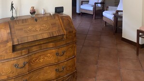 A room with a wooden dresser, a mirror, wall sconces, and a painting. - "COTTAGE ULIVO" 
Codice Identificativo: 046017LTN2254 (Lucca)