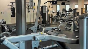A gym with various exercise equipment, including weight machines and treadmills. - Hill Country Hiatus! (Bee Cave)