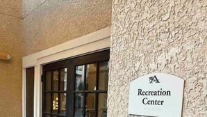 A door with a frosted glass panel and a sign above it that reads "Recreation Center". - Hill Country Hiatus! (Bee Cave)