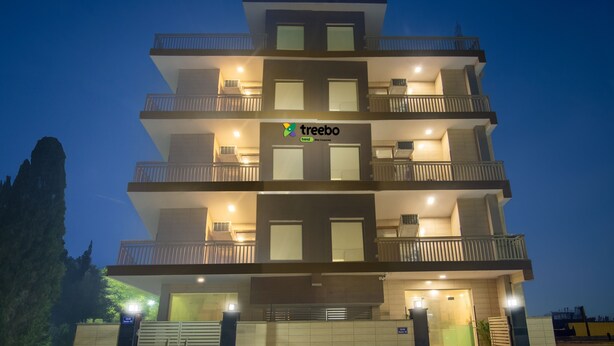 A multi-story building with balconies and a sign reading "treebo". - Treebo Elite Corporate, Sector 62 (New Delhi)
