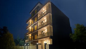 A multi-story building with balconies, a visible logo, and a gated entrance. - Treebo Elite Corporate, Sector 62 (New Delhi)