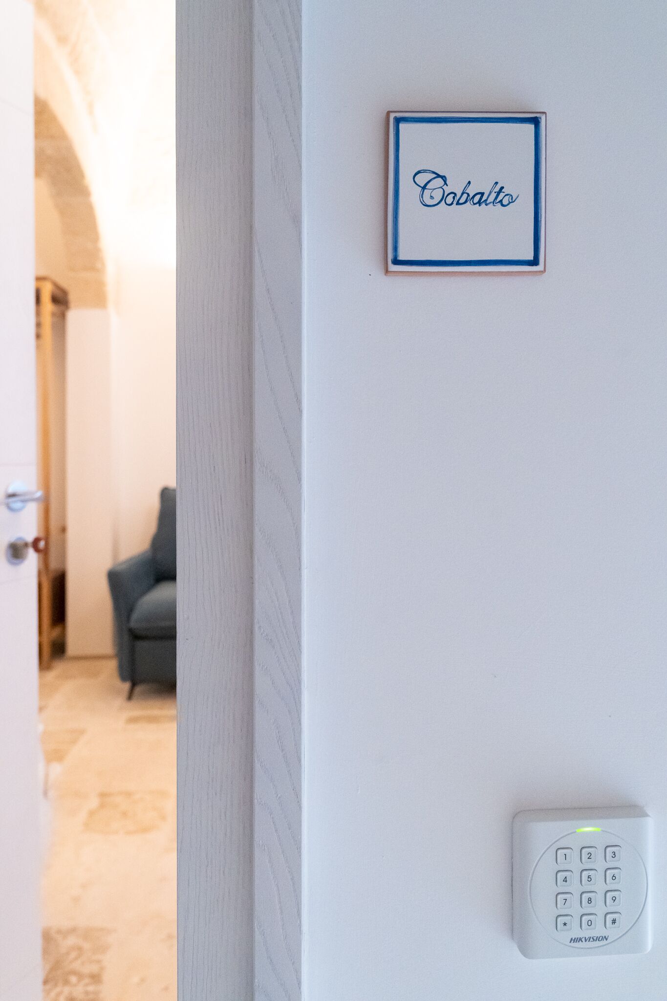 A wall-mounted device with a keypad and a framed sign above it.
