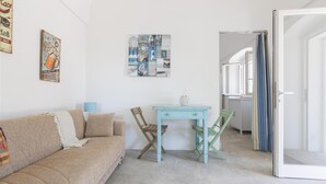 A room with a beige sofa, a small table, and a wall art piece. - 805 La Murreddina by Barbarhouse (Ostuni)