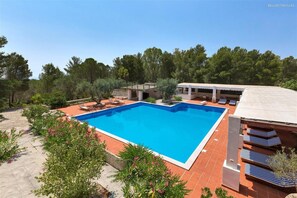 A swimming pool with a surrounding patio, a covered seating area, and a view of trees. - 836 Masseria Colosso - Pajara (Patu)