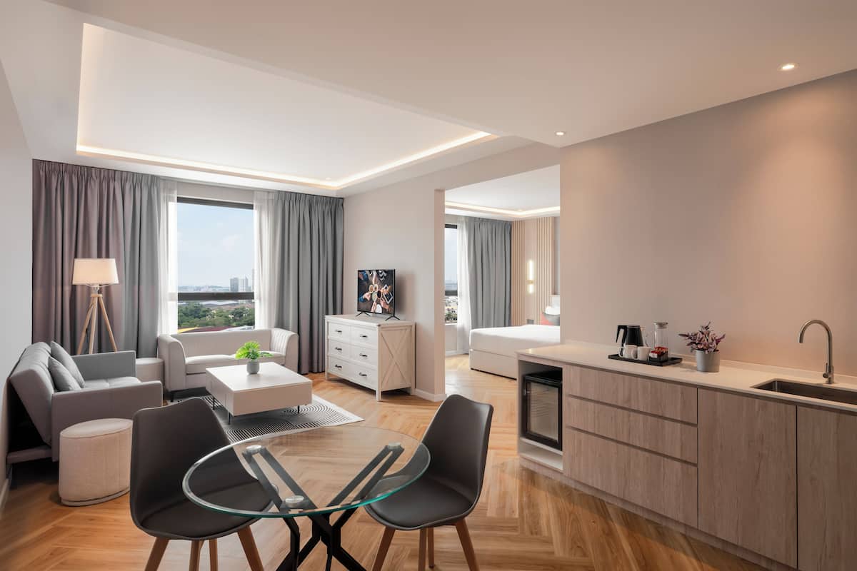 A modern apartment with a living area, dining space, and kitchen.