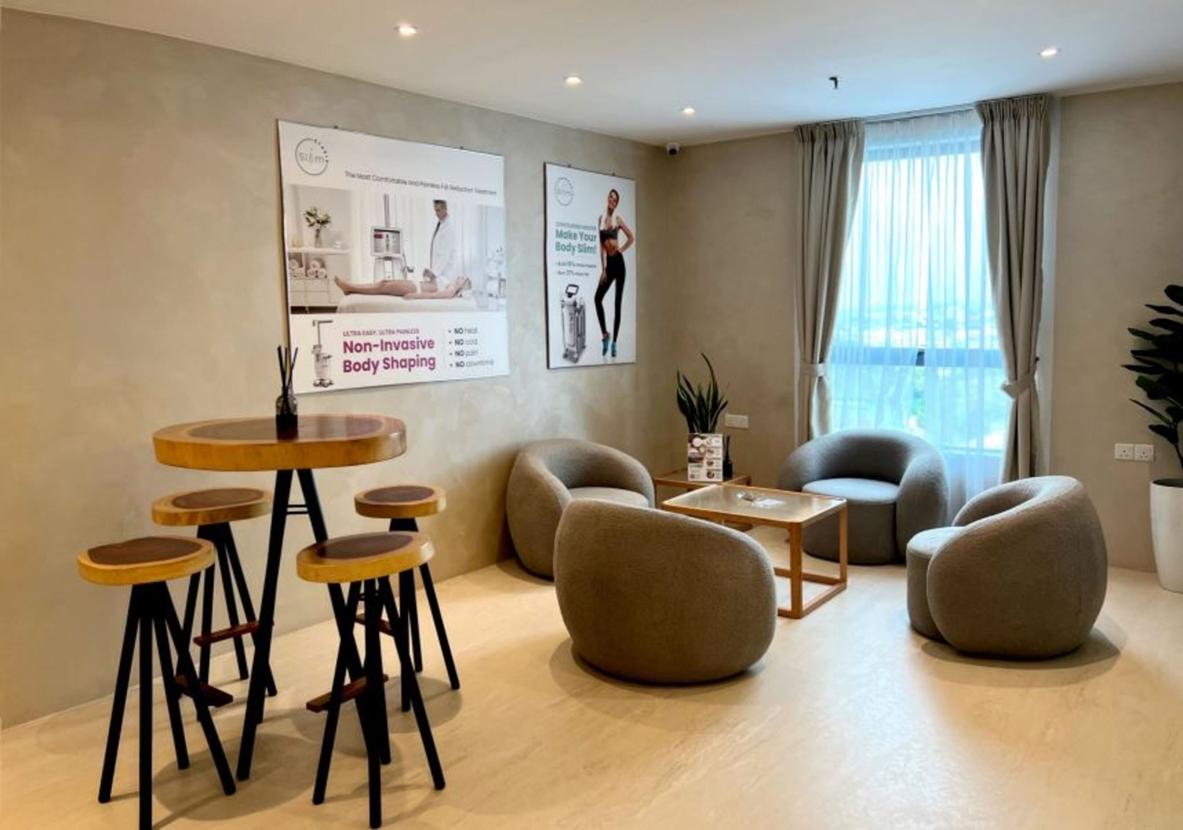 A modern lounge area with round wooden tables and comfortable seating.