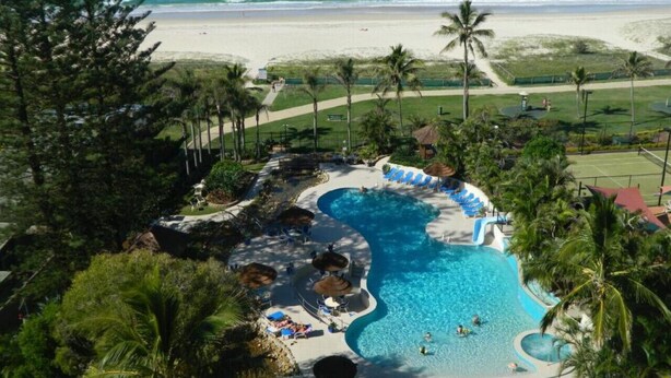 A resort pool with a view of the beach and ocean. - Royal Palms Uninterrupted Views (Palm Beach)
