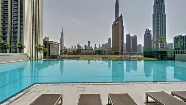 Outdoor pool - SuperHost - Downtown Delight 2BR Apt Opposite Burj Khalifa (Dubai)