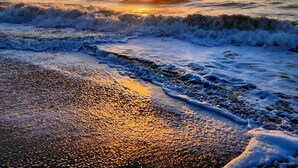 A beach scene with waves and a sunset. - Romantic 14th floor w/ a WOW view! Oceanfront King, full condo, pools & hot tubs (Myrtle Beach)