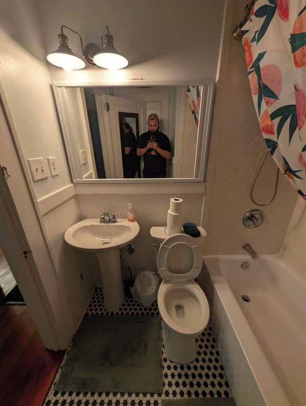 A bathroom with a sink, toilet, and bathtub.