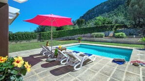 A swimming pool with lounge chairs and a red umbrella. - Ca Na Lida - Two Bedroom Villa, Sleeps 4 (Mallorca)