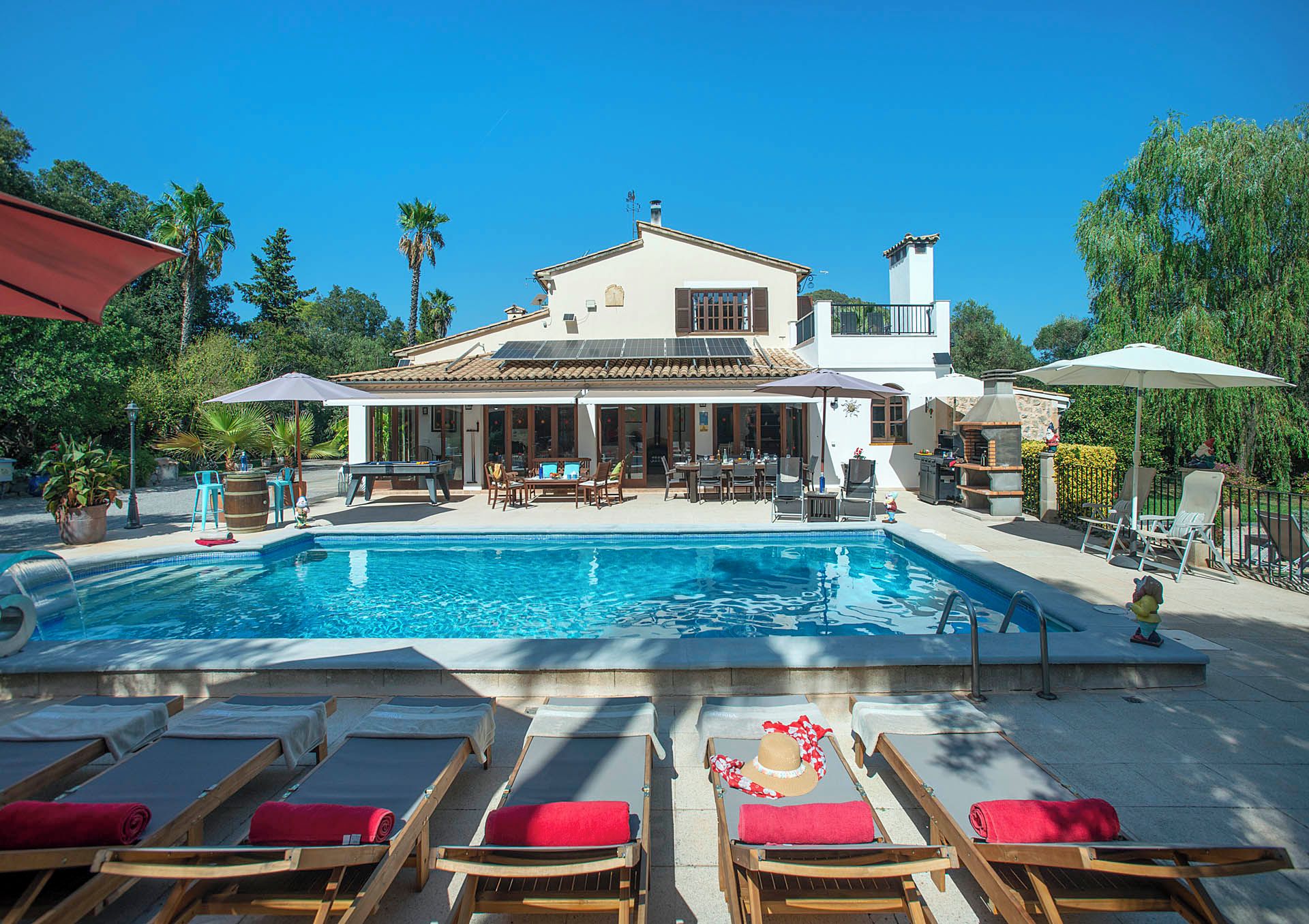 A poolside area with lounge chairs and a pool.