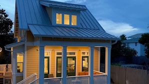 A two-story house with a covered porch and a hot tub in the backyard. - Gorgeous new beach cottage in fantastic location! (Destin)