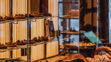A bakery display with various baked goods and pastries.