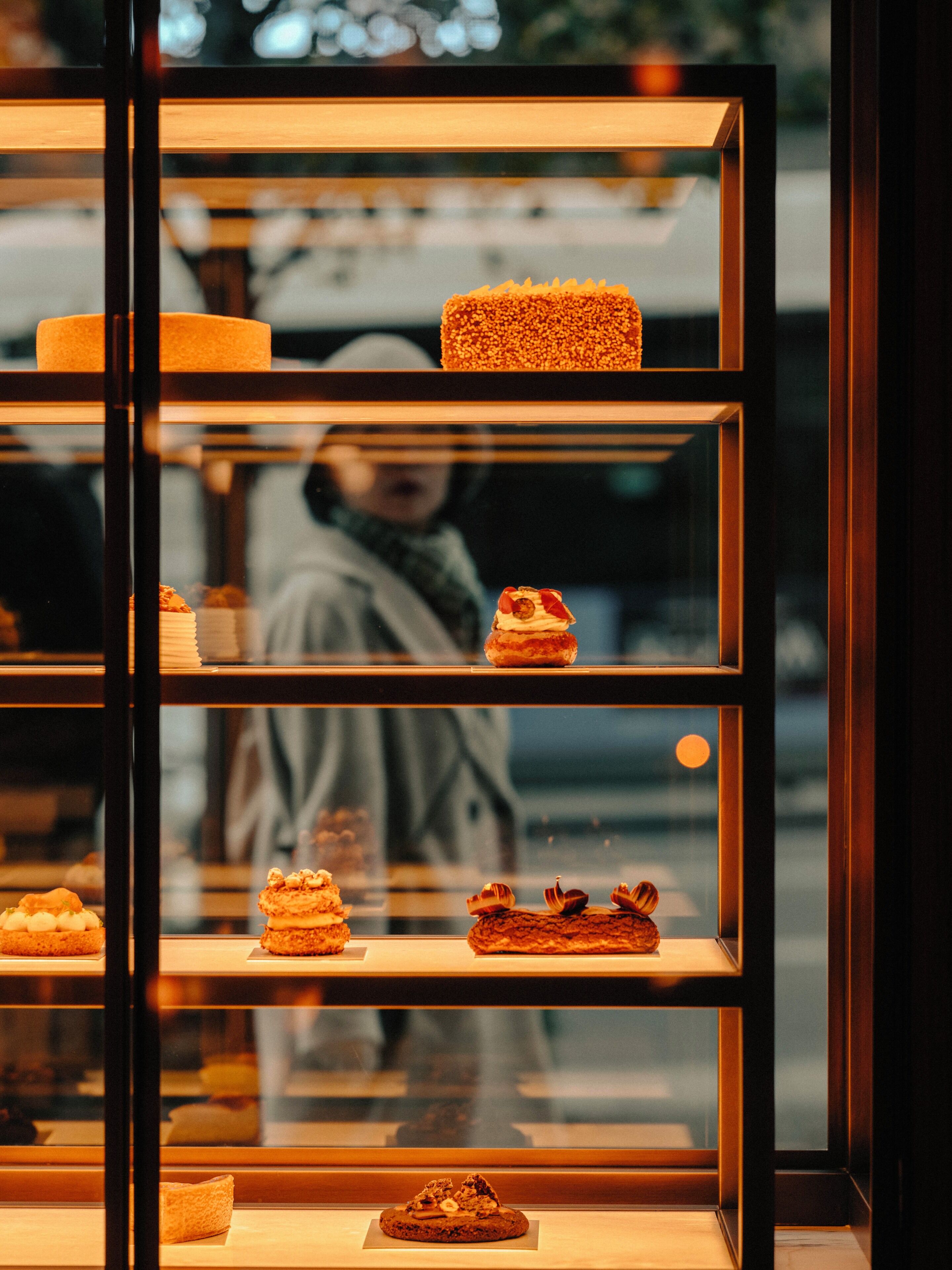 A dessert display case with various pastries and cakes.