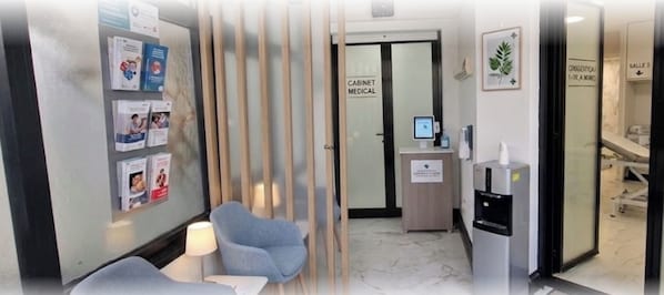 A medical facility with a reception area, a medical cabinet, and a water dispenser.