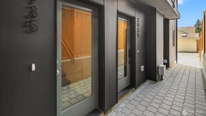 A modern building with large glass doors and a dark facade. - Seattle Charm|Near University|3 BR|W&D|WIFI (Seattle)