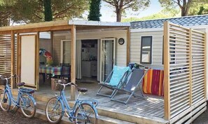 Enjoy outdoor dining and relaxation on the covered porch, complete with a table and chair.