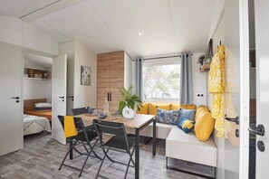 Cozy living space with a dining area, sofa, and bench, perfect for relaxing and socializing.