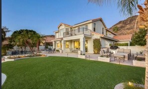 A two-story house with a large front yard, outdoor seating area, and a pool. - Lakefront Getaway with Infinity Pool and Pontoon (Glendale)