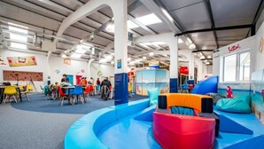 A children's play area with colorful seating and a slide. - Beautiful seaside retreat close to North Devon's white sandy beaches! (Wrafton)