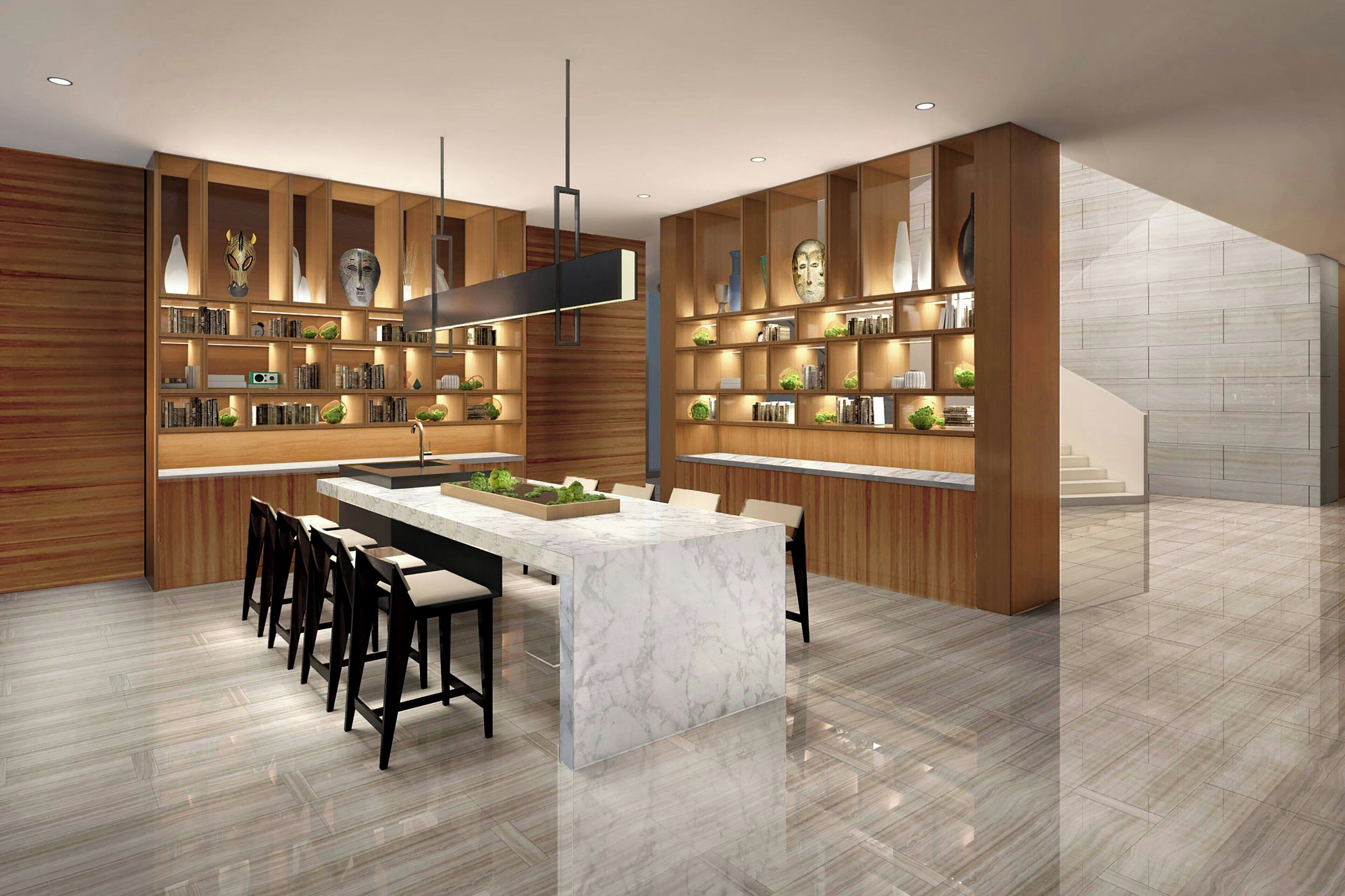 A modern kitchen with a marble island, wooden shelving, and a staircase.