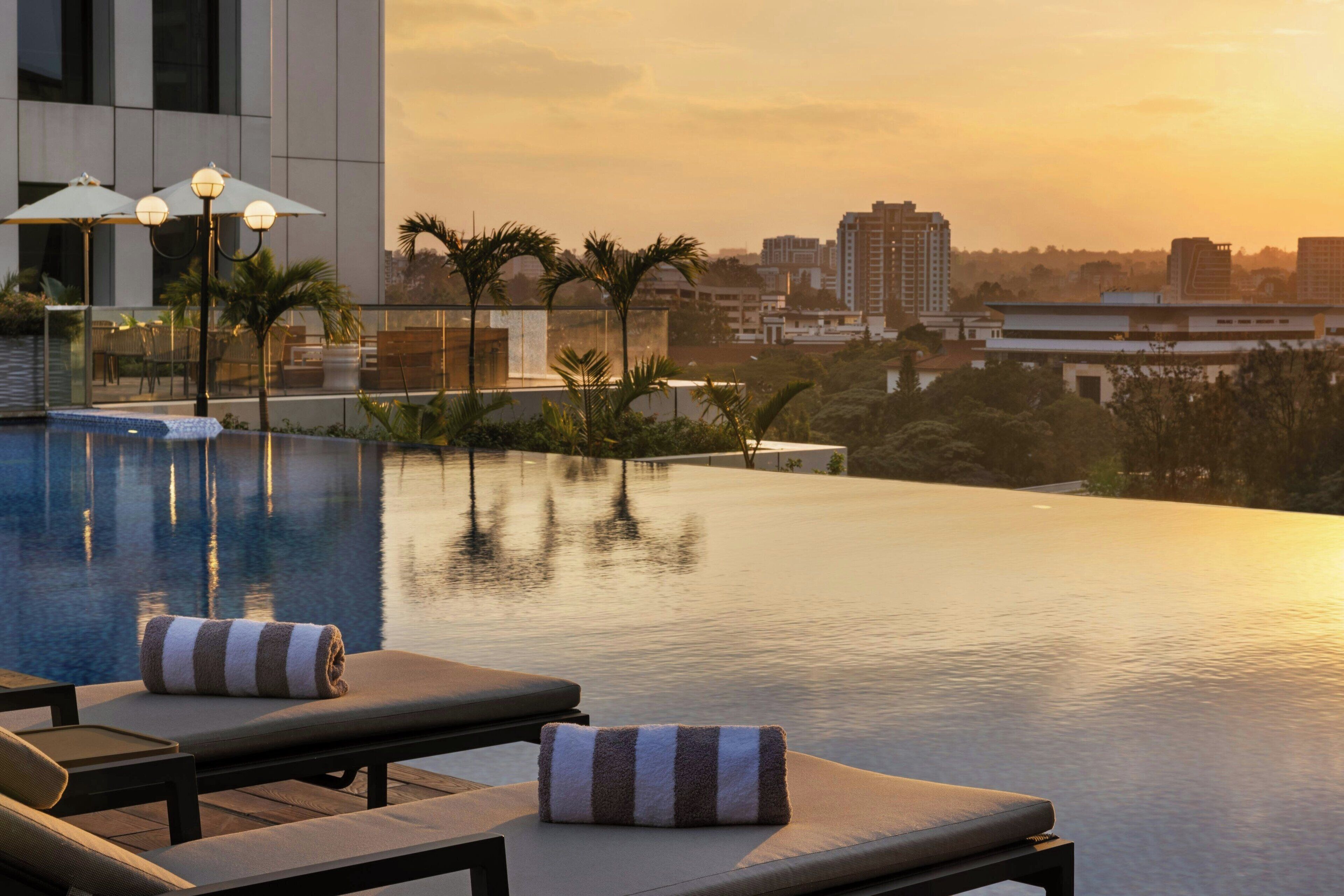 Outdoor pool, open 6:00 AM to 10:00 PM, pool umbrellas, sun loungers