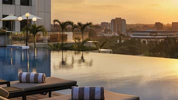 Outdoor pool, open 6:00 AM to 10:00 PM, pool umbrellas, sun loungers