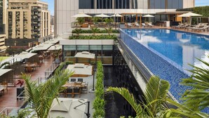 A rooftop pool area with lounge chairs, umbrellas, and outdoor seating. - JW Marriott Hotel Nairobi (Nairobi)