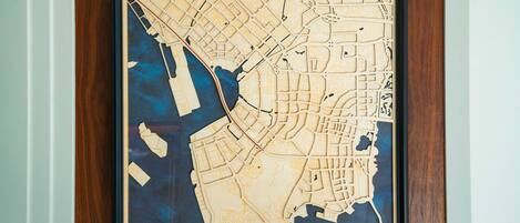 A framed city map with a wooden border.