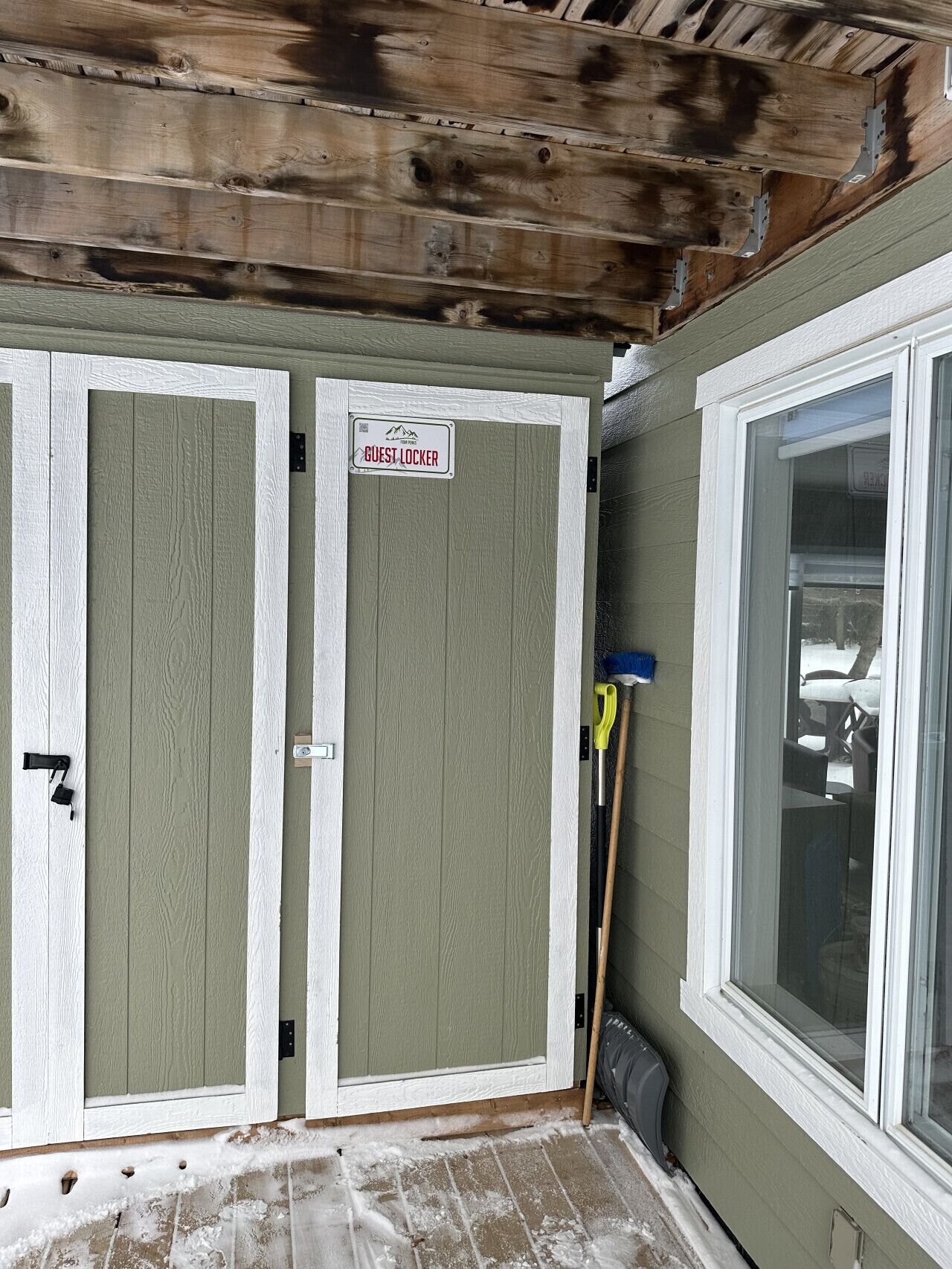 A guest locker with a sign, a window, and a door with a handle.