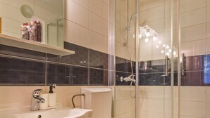 A modern bathroom with a glass shower enclosure, a white sink, and a toilet. - BIS Studio Apartment 3 (Dubrovnik)